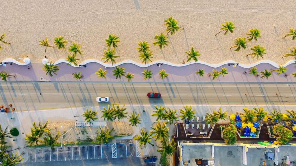 beach, buildings, cars, palm trees, road, sand, beach side, seaside, nature, street, shadows, top view, aerial view, bird's eye view, drone photography, aerial photography