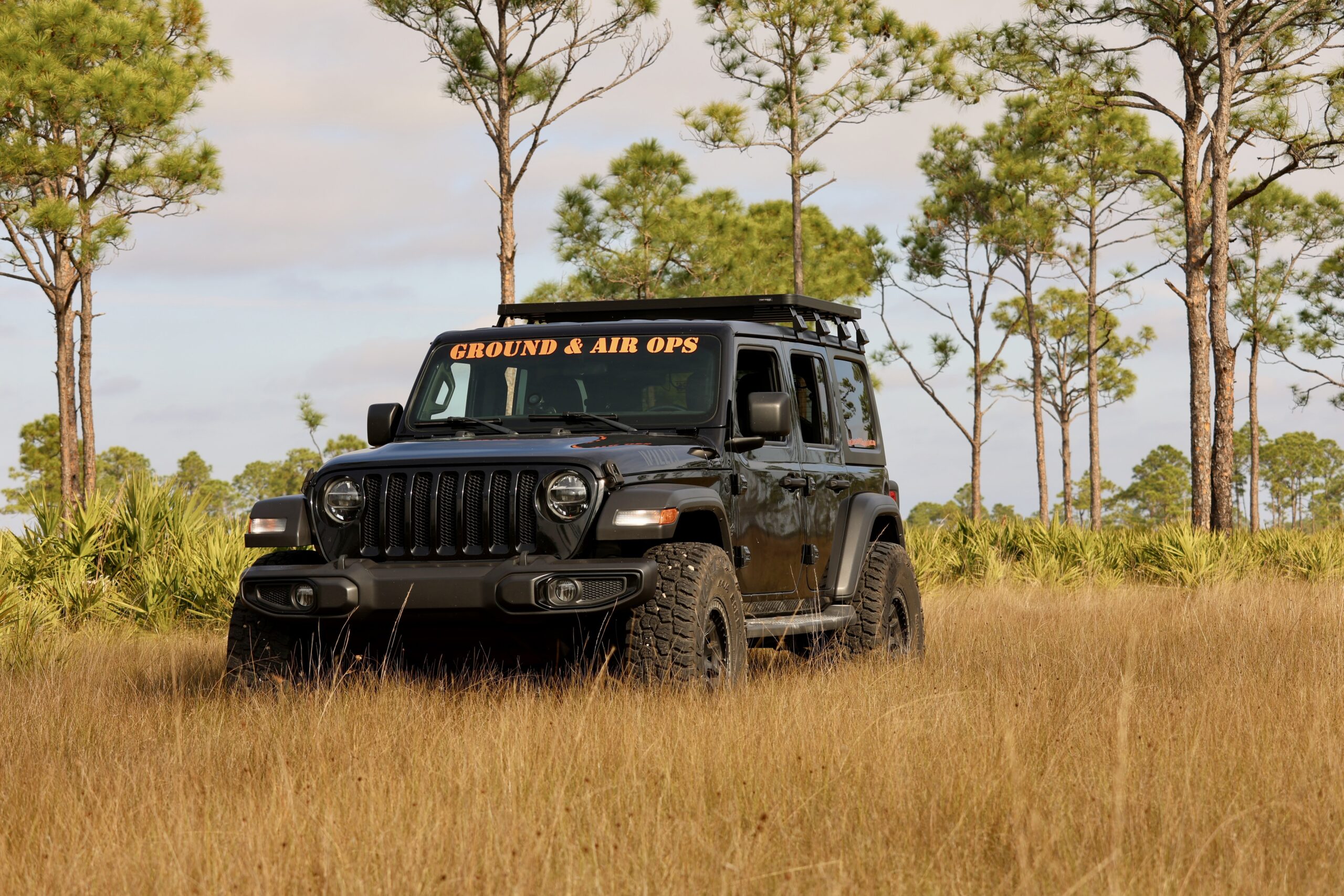 Kent Corey, founder of Corey Ground & Air Ops, standing with his 4WD mobile studio and drone equipment in a Florida field.